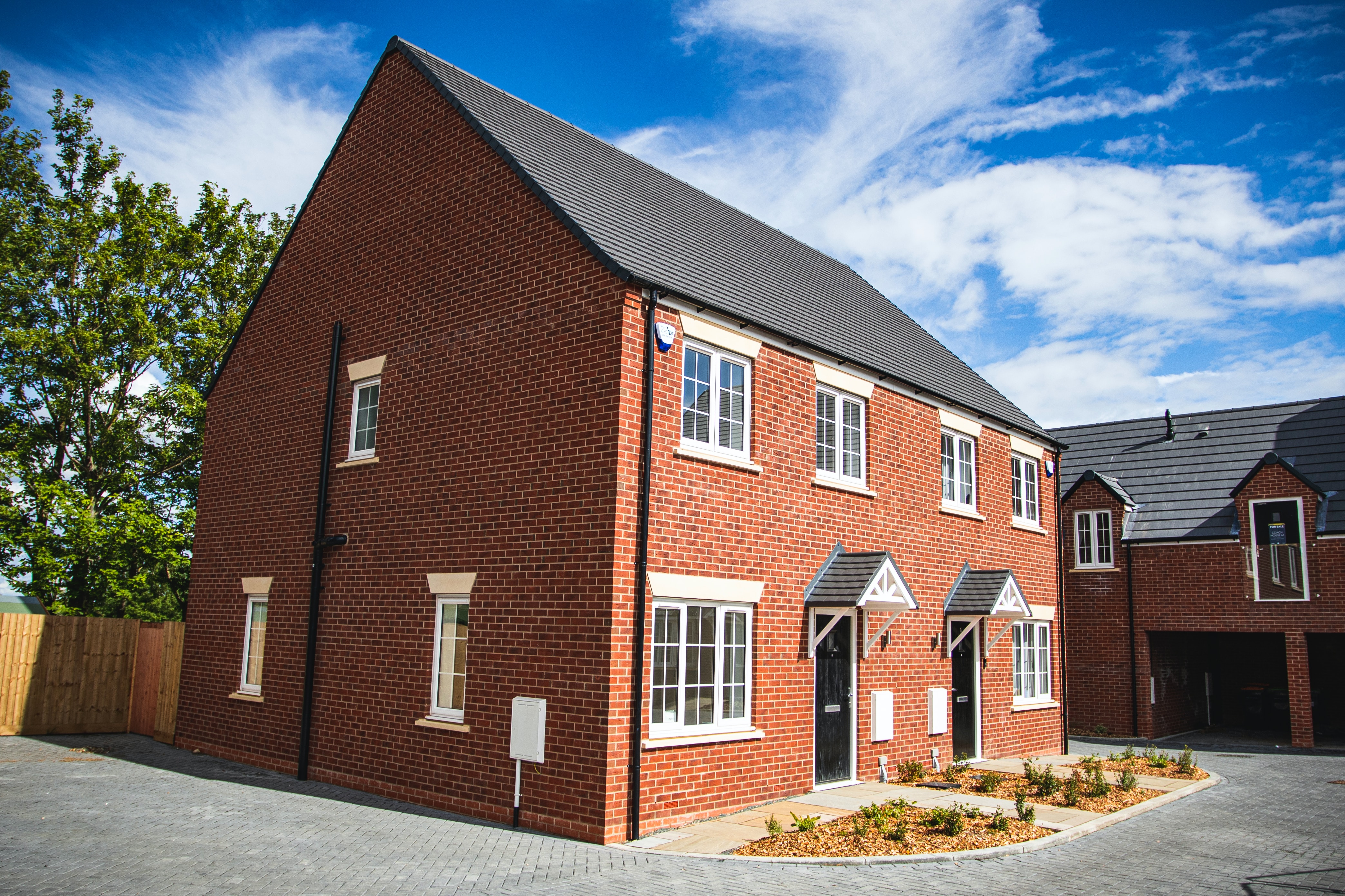 A red brick house with a grey roof